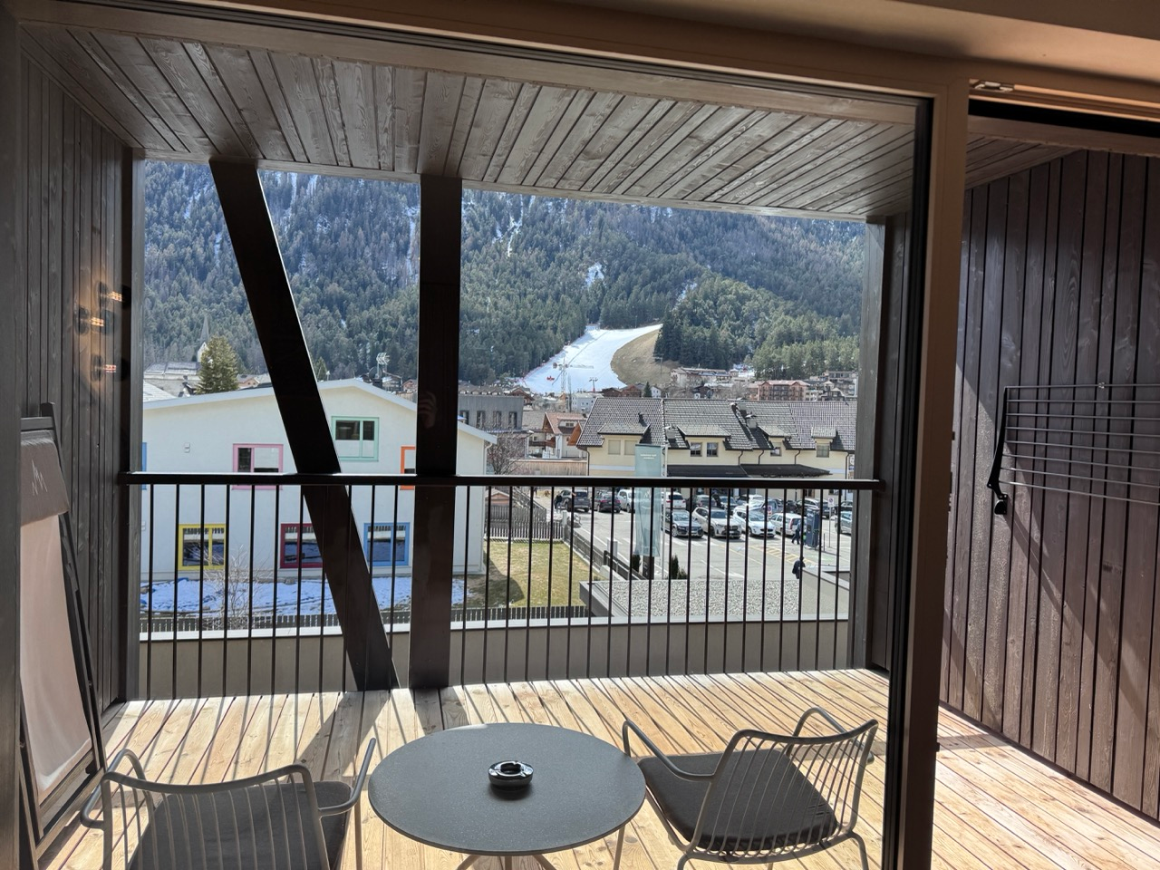 AMA Stay balcony with seating and view toward the ski slope above San Vigilio
