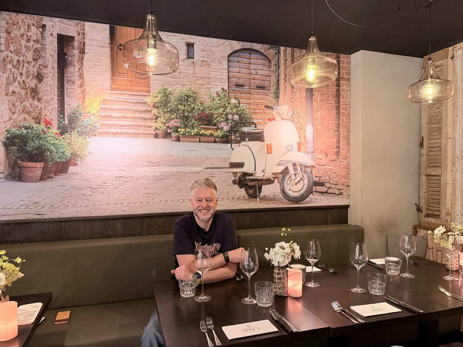 Manca Veldhoven dining room with Italian street mural and table setting