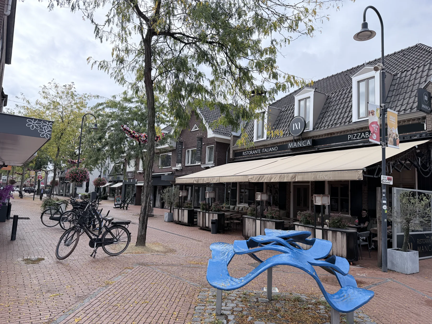 Manca Veldhoven restaurant exterior on Kromstraat with storefront and terrace